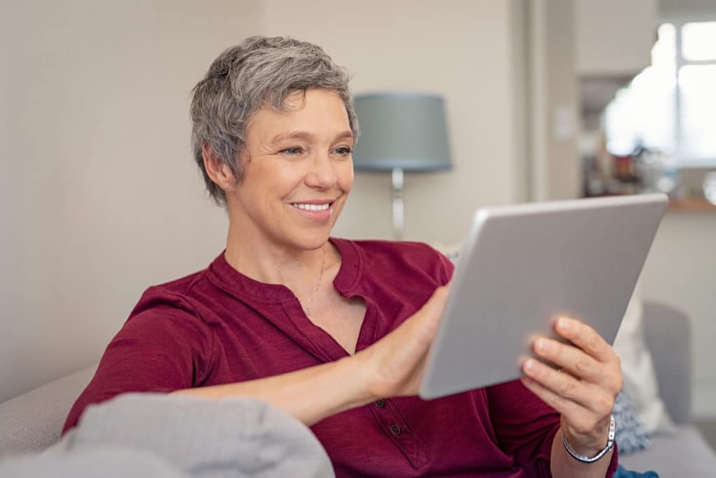 Smiling Woman Looking at Websites | Medicare Plan Finder