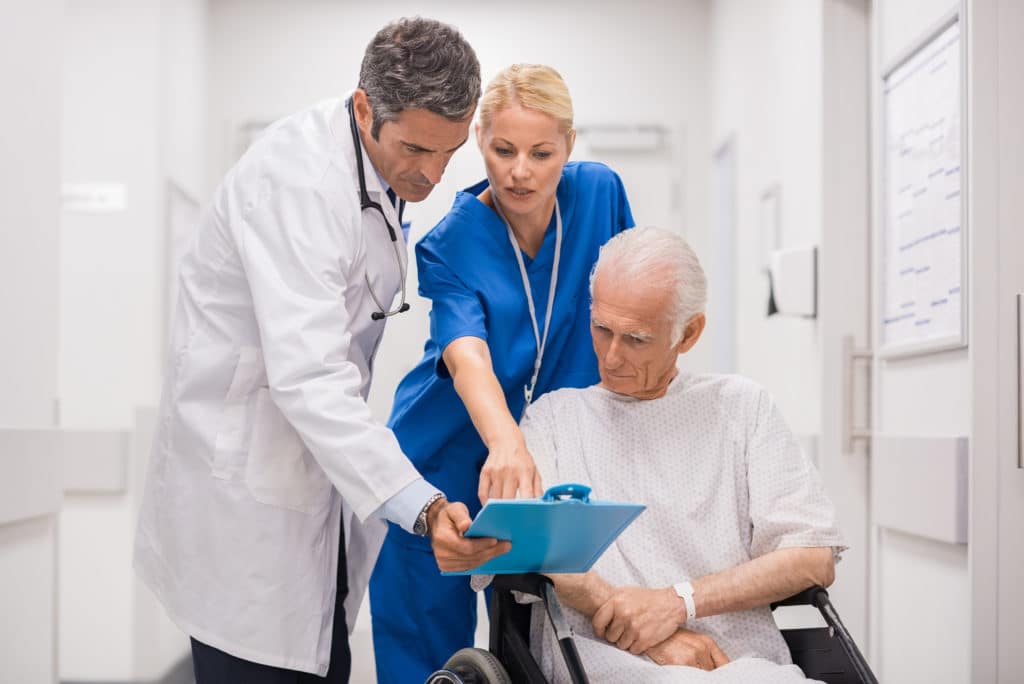 Doctor and Nurse Discussing Cancer Risk With Patient | Medicare Plan Finder
